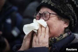 A relative of a passenger of the aircraft that crashed after it went off the runway reacts at Muan International Airport in Muan, South Korea, Dec. 29, 2024.