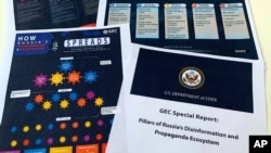 FILE - Pages related to Russia's disinformation campaign are seen in the U.S. State Department's Global Engagement Center report released Aug. 5, 2020.