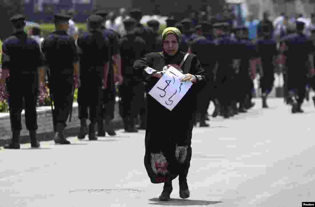A protester wears a chain with many amulets as he joins others in a march towards central Bangkok, Thailand. Thousands of people took to the streets of the Thai capital after lawmakers approved a draft political amnesty bill that could allow the return of self-exiled former premier Thaksin Shinawatra.