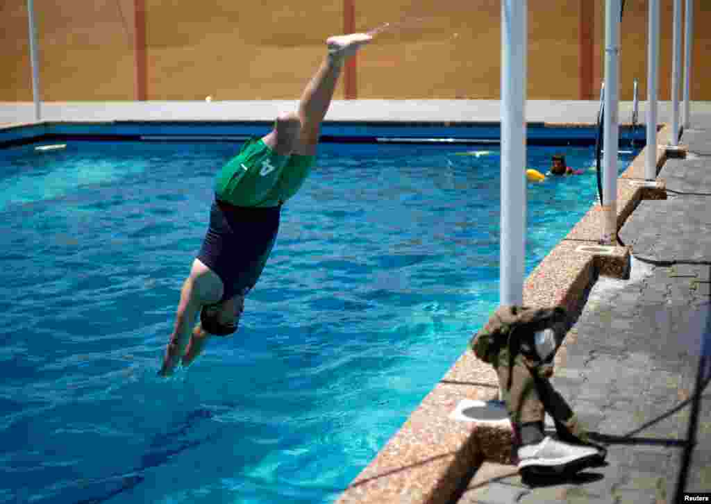 A Palestinian amputee, who lost a leg in a round of violence with Israel, takes part in a swimming training session in Gaza City, July 29, 2019.