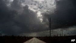 Rain before the arrival of what became Tropical Storm Humberto falls on the windshield of a car in the aftermath of Hurricane Dorian at Mclean's Town, Grand Bahama, Bahamas, Sept. 13, 2019.