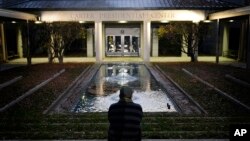 Royce Soble, of Atlanta, sits near a reflection pool at The Carter Center after former first lady Rosalynn Carter has died, Nov. 19, 2023, in Atlanta. "I just wanted to sit here and share a moment of peace and say my respects for the family," Soble said. 