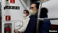Park Gyung-sun, 71, rides on a subway to deliver a parcel in Seoul, South Korea, Feb. 8, 2023.