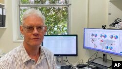 Peter Janssen, a principal scientist at AgResearch, sits at his desk in Palmerston North, New Zealand on Nov. 3, 2022.