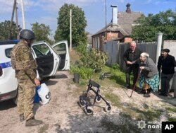 Police evacuate people following the Russian attack around the town of Vovchansk in the Kharkiv region, Ukraine, on May 10, 2024. (Ukrainian Police via AP)