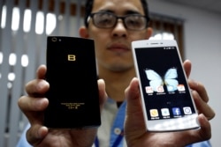 FILE - A man presents the Vietnamese smartphones Bphones at BKAV factory in Hanoi, Vietnam, July 5, 2017.