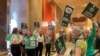 FILE - Supporters of a proposed Minnesota Equal Rights Amendment, known as the ERA, held signs support outside the Minnesota House in the State Capitol building in St. Paul, Minnesota, May 17, 2024. 