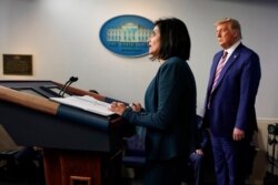 President Donald Trump listens as the administrator of the Centers for Medicare and Medicaid Services, Seema Verma, speaks during a news conference at the White House in Washington, Nov. 20, 2020.