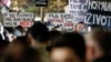 Protesters hold placards during a rally in front of the Interior Ministry building demanding resignations after the Cetinje shooting rampage, in Podgorica, Montenegro, Jan. 5, 2025.