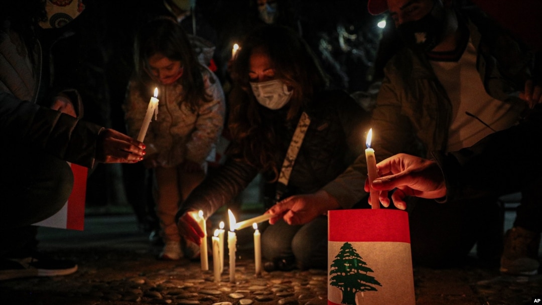 Lebanese residents in Chile hold a vigil for the victims of the deadly explosion which devastated the port and large parts of Beirut, in front of the Lebanon Embassy in Santiago, Chile, Aug. 10, 2020.