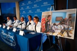 A photo of a patient being transported is displayed while medical staff at Henry Ford Hospital answer questions during a news conference in Detroit, Nov. 12, 2019.