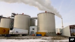 FILE - Steam blows over fermentation tanks at the Green Plains ethanol plant in Shenandoah, Iowa, Jan. 6, 2015. 