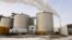 FILE - Steam blows over fermentation tanks at the Green Plains ethanol plant in Shenandoah, Iowa, Jan. 6, 2015. 