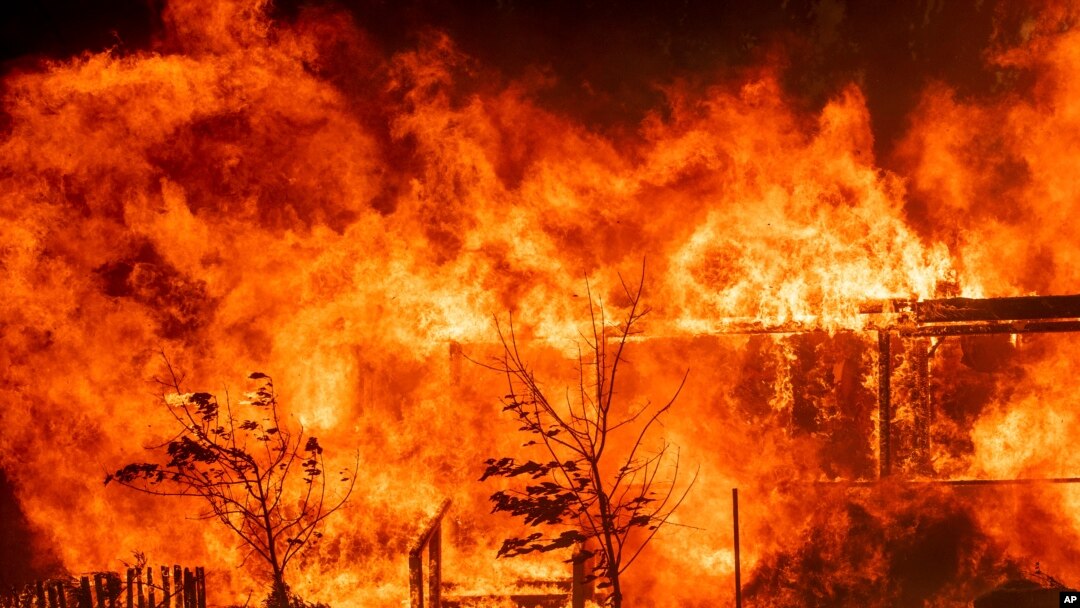 Flames consume a home as the River Fire tears though Lakeport, Calif., July 31, 2018.