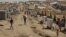 Syrian refugees walk through the Dumez refugee camp in Dahuk, northwest of Baghdad, Iraq, August 13, 2012. 
