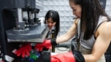 Debbie Wu operates miniTrashpresso, which turns plastic waste into materials to make sunglasses, at Trash Kitchen in Taipei, Taiwan August 19, 2024. (REUTERS/Ann Wang)