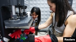 Debbie Wu operates miniTrashpresso, which turns plastic waste into materials to make sunglasses, at Trash Kitchen in Taipei, Taiwan August 19, 2024. (REUTERS/Ann Wang)