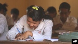 A girl sits in a history class at the local high school in Kampong Trach, Cambodia