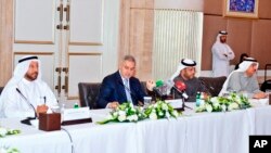 This Jan. 20, 2019 picture made available by the Emirates News Agency, WAM, shows Syrian businessman and lawmaker Mohammed Hamsho, second left, at a trade forum launched Sunday, in Abu Dhabi, United Arab Emirates.