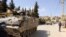 FILE - Lebanese army soldiers patrol the Sunni Muslim border town of Arsal in an armored vehicle.