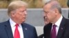 President Donald Trump, left, talks to Turkish President Recep Tayyip Erdogan, right, as they tour the new NATO headquarters in Brussels, Belgium, July 11, 2018. 