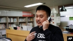 In this May 11, 2020 photo, Lee Jong-geol, general director of the gay rights advocacy group Chingusai talks on the phone before an interview in Seoul, South Korea. As South Korea grapples with a new spike in coronavirus infections thought to be…