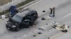 A law enforcement officer looks over the evidence near the remains of a SUV involved in the Wednesdays attack is shown in San Bernardino, California, Dec. 3, 2015. 