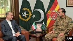 TOPSHOT - This handout photograph taken and released by the Pakistan's Inter Service Public Relation (ISPR) on January 29, 2024 shows Pakistan's Army Chief General Syed Asim Munir (R) speaking with Iranian Foreign Minister Hossein Amir-Abdollahian during 