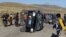 People surround an overturned car during a protest at the Tinaya copper mine owned by Swiss-based Xstrata plc in Espinar, Peru, May 28, 2012. 