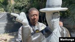 David Ngwerume working on his most talked about piece, which encourages people to mask up, in an exhibit called: “MJ" named after the late U.S. pop icon “Michael Jackson,” Harare, April 23, 2021. (VOA/Columbus Mavhunga)
