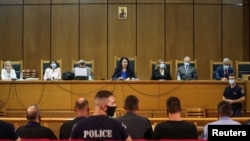 Presiding judge Maria Lepenioti attends a trial of leaders and members of the Golden Dawn far-right party in a court in Athens, Greece, Oct. 7, 2020. 