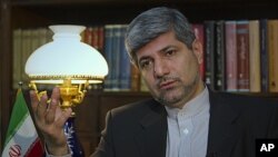 Iranian Foreign Ministry Spokesman Ramin Mehmanparast speaks with a Reuters correspondent during an interview in Tehran, June 29, 2011