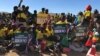 Members of Zanu PF rally in Mutoko, about 200km east of Harare displaying to President Emmerson Mnangagwa on June 9, 2018 what they want him address if he wins the July 30 Zimbabwe general election.