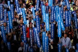 FILE - Delegates hold Hillary Clinton signs at the Democratic National Convention in Philadelphia, Pa., July 28, 2016.