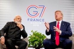 FILE - President Donald Trump, accompanied by Indian Prime Minister Narendra Modi, left, speaks during a bilateral meeting at the G-7 summit in Biarritz, France, Aug. 26, 2019.