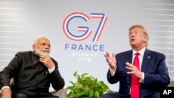 FILE - President Donald Trump, accompanied by Indian Prime Minister Narendra Modi, left, speaks during a bilateral meeting at the G-7 summit in Biarritz, France, Aug. 26, 2019.