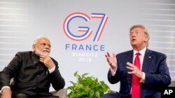 President Donald Trump, accompanied by Indian Prime Minister Narendra Modi, left, speaks during a bilateral meeting at the G-7 summit in Biarritz, France, Aug. 26, 2019.