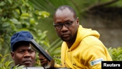 FILE - Activist Pastor Evan Mawarire is taken into a vehicle by police outside his home in Harare, Zimbabwe, Jan. 16, 2019.