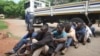 A policeman stands guard as some of the people arrested during demonstrations over the hike in fuel prices, make their court appearance at the magistrates courts in Harare, Zimbabwe, Wednesday, Jan,16, 2019. 