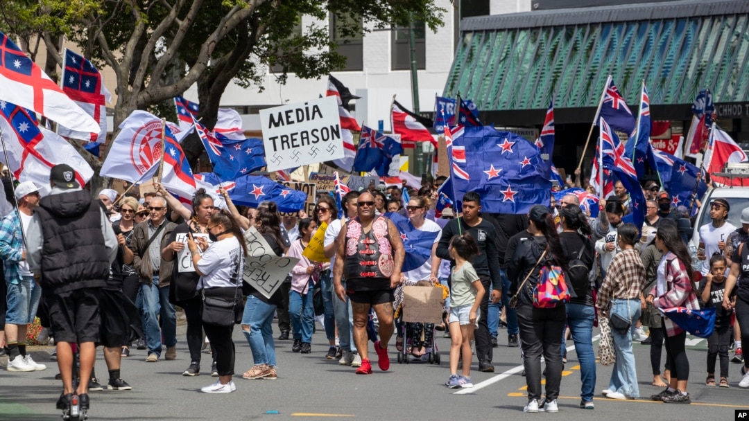 Freedom and Rights Coalition demonstrators march along Lambton Quay before gathering at Parliament, in Wellington, New Zealand on Nov. 9, 2021.