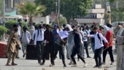 Mahasiswa melemparkan batu ke arah polisi dalam aksi protes atas dugaan pemerkosaan di kampus di Punjab, Rawalpindi, Pakistan, 17 Oktober 2024.