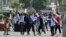 Students throw stones at police during clashes as they protest over an alleged on-campus rape in Punjab, in Rawalpindi, Pakistan, Oct. 17, 2024.