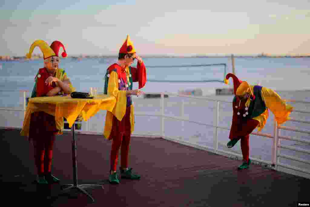Costumed party-goers take a break outside the 11th annual Gecko Ball, an annual party and fundraiser with guests in costume, in Gulfport, Florida.