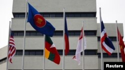 FILE - Flags are seen outside the Association of Southeast Asian Nations (ASEAN) secretariat building, ahead of the ASEAN leaders' meeting in Jakarta, Indonesia, April 23, 2021. REUTERS/Willy Kurniawan