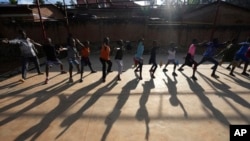 FILE - Children practice the sport of fencing, on the outskirts of Kigali, Rwanda, April 4, 2024. 