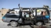 Afghan journalists film the site of a bomb explosion in Kabul, Afghanistan, June 3, 2021. 