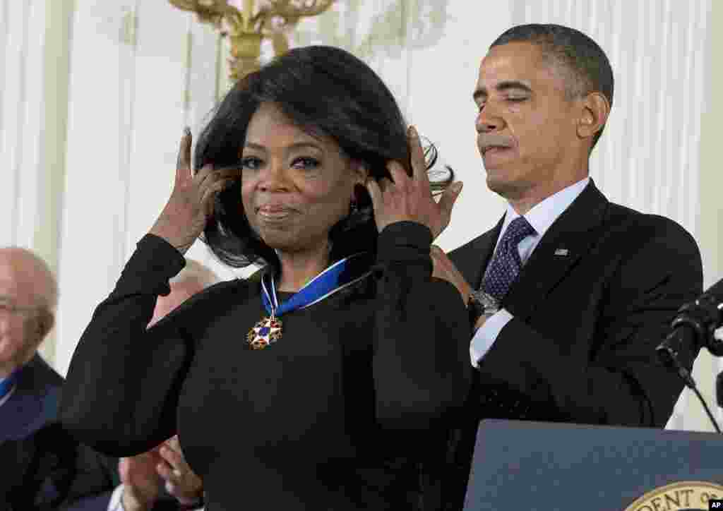 U.S. President Barack Obama awards Oprah Winfrey the Presidential Medal of Freedom during a ceremony in the East Room of the White House in Washington.