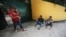 FILE - Honduran migrants making their way north to the US border, rest in Tecun Uman, Guatemala, Jan. 20, 2021, on the border with Mexico.