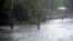 A man walks through a flooded road in the coast of the Indian Ocean Island of Mauritius February 20, 2023. The country is bracing for Tropical Cyclone Belal on Monday, January 15, 2024.