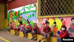 Students from the Sovannaphumi school wearing face masks maintain social distancing as Cambodia reopen schools and museums after months of shutdown due to surging of the coronavirus disease (COVID-19) in Phnom Penh, Cambodia, January 4, 2021. (REUTERS)